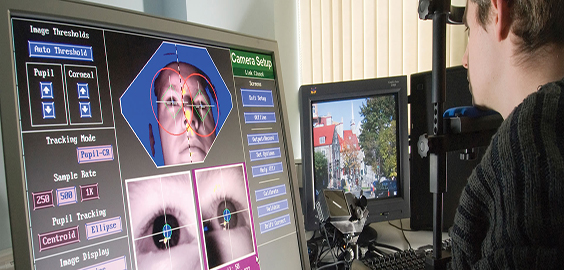a man standing in front of a computer screen