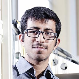 a man wearing glasses and looking at the camera