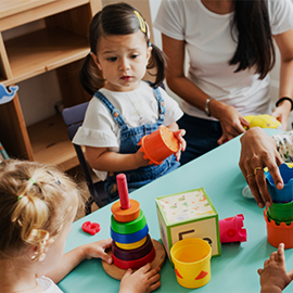 children at teachers sitting at table