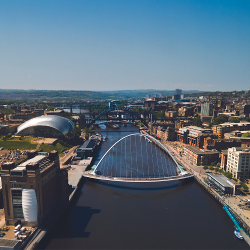 A image of a city landscape with a river running through the centre.