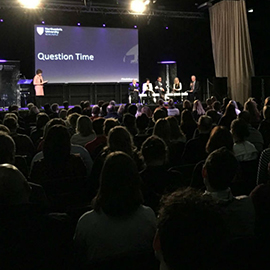 a large crowd of people in a dark room