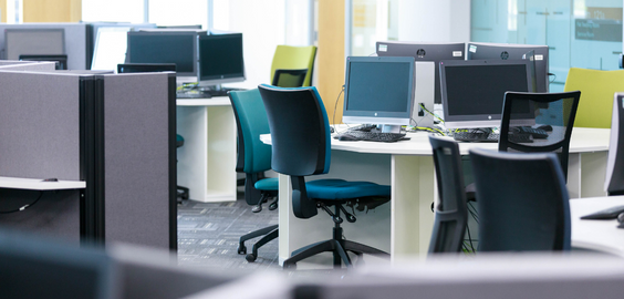 Photo of computers, desks and office chairs