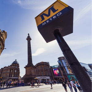 Photo of metro sign in front of busy street