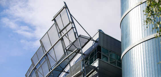 Corner of an abstract building against a blue sky