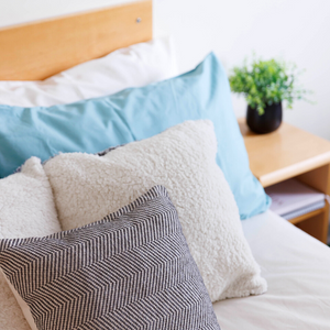 Blue and Grey Pillows on a bed
