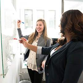 woman writing on whiteboard