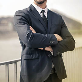 man in suit with arms crossed