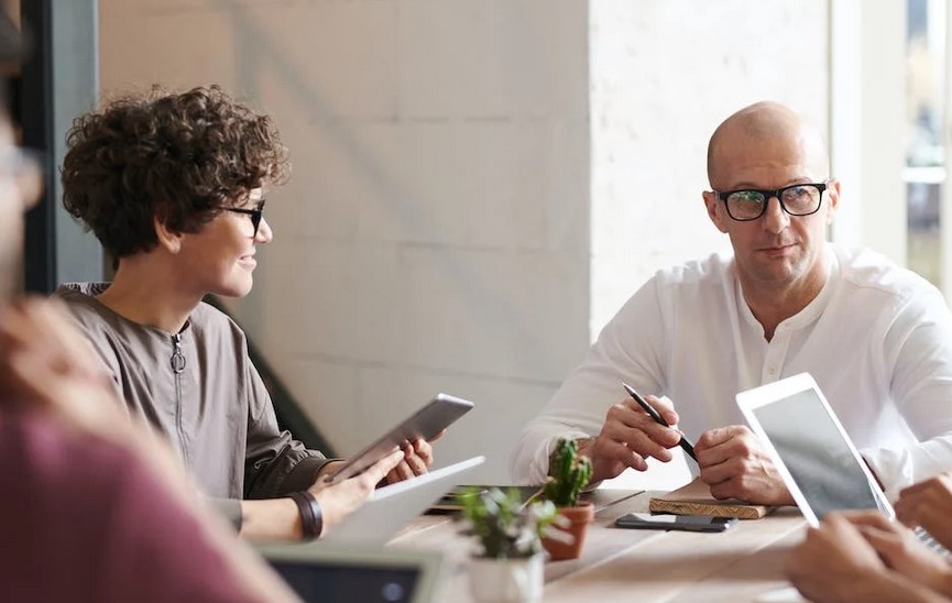 man and woman in a meeting room