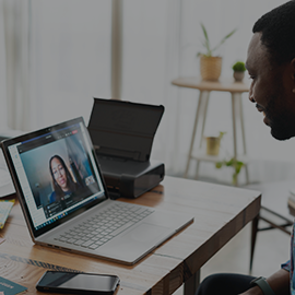 Male talking to student on laptop screen