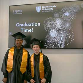 2 students smiling in their graduation outfits for High Tunstall