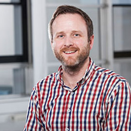 a man standing in front of a window