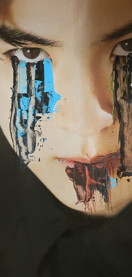 A mans face with paint coming down from the eyes and mouth