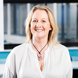 blonde lady wearing white shirt smiling