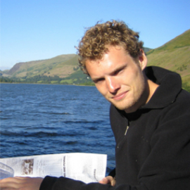 a man holding a fish in the water