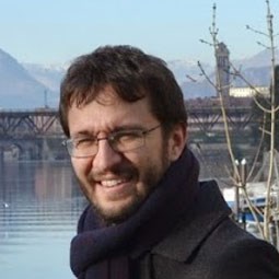 a man standing in front of a body of water