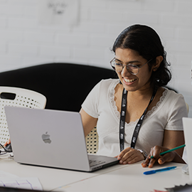 student smiling on laptop