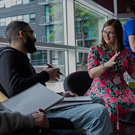 Staff member helping student