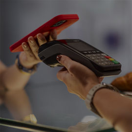 Image of a person paying with their smartphone via contactless pay